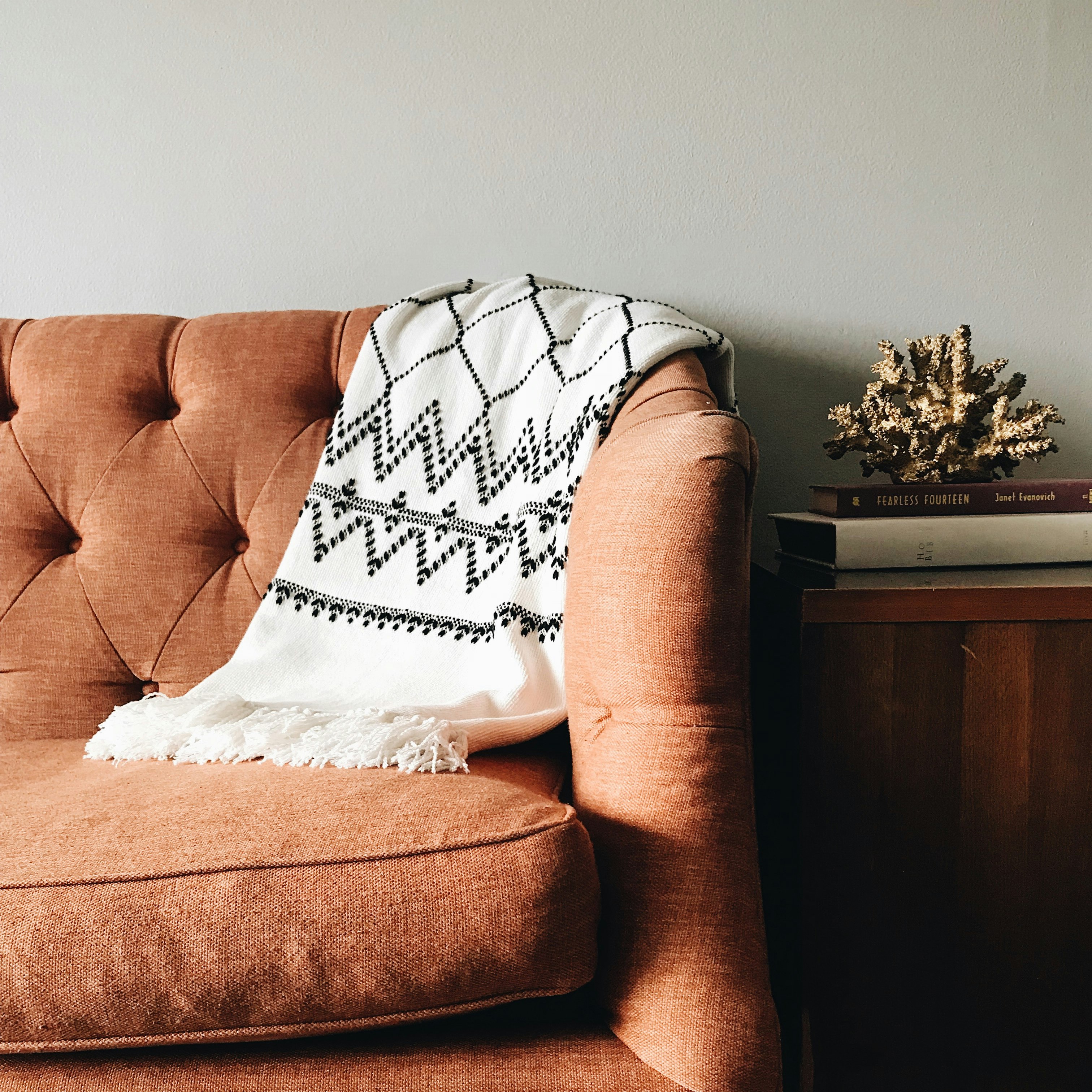 white and black textile on brown couch