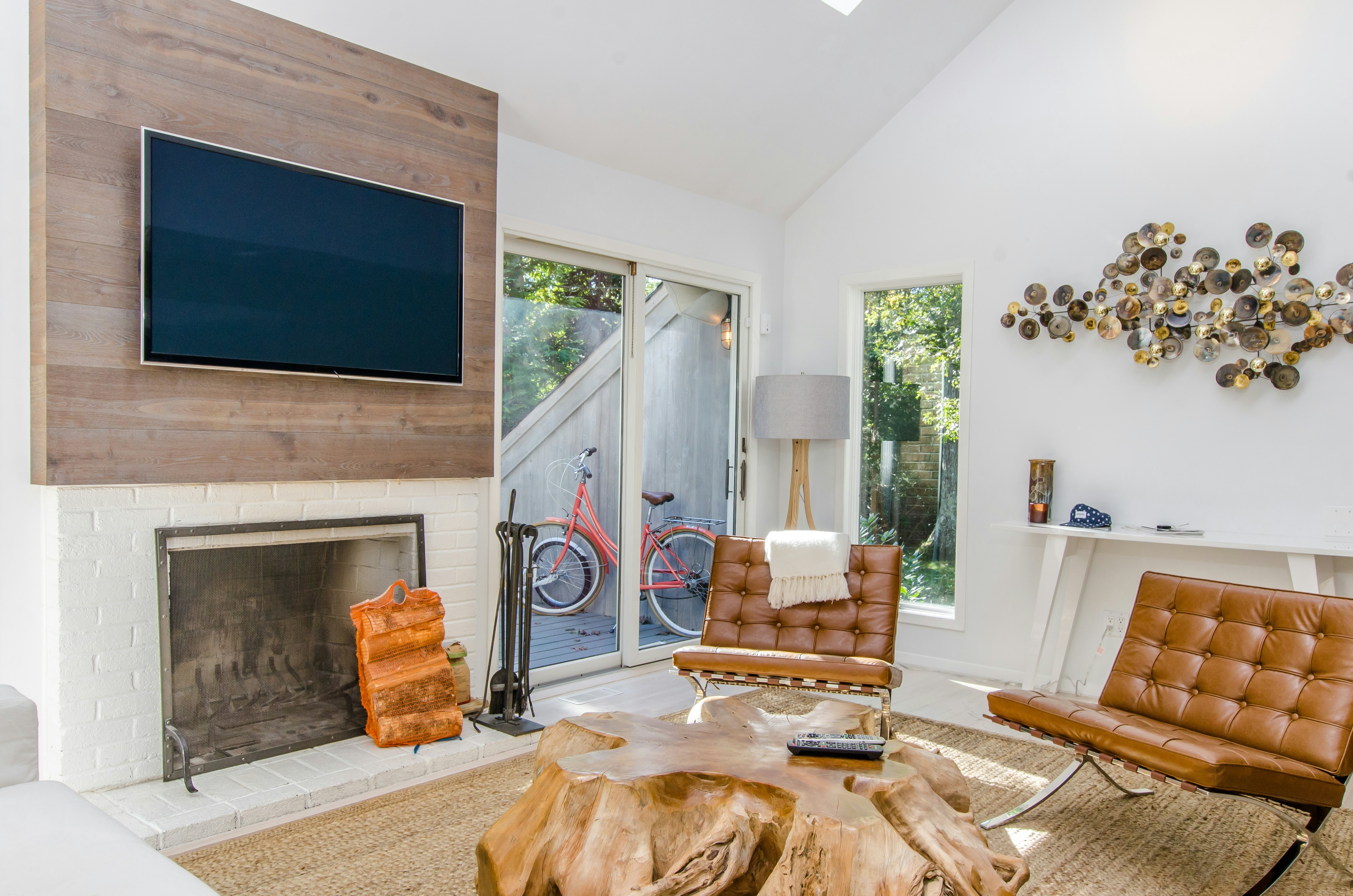 two tufted brown leather chairs in front of brown wood stump center table