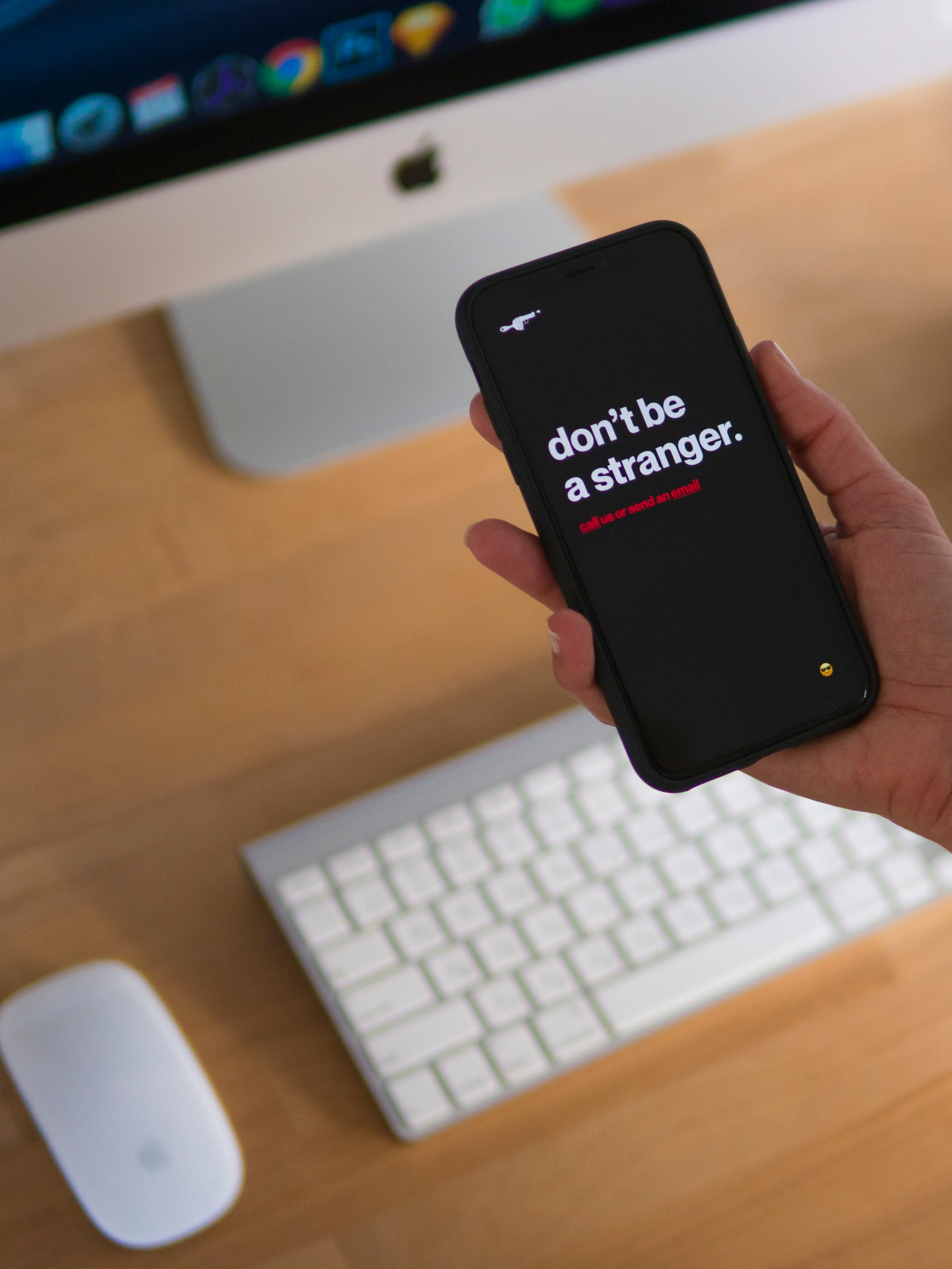 person holding black iPhone displaying don't be stranger