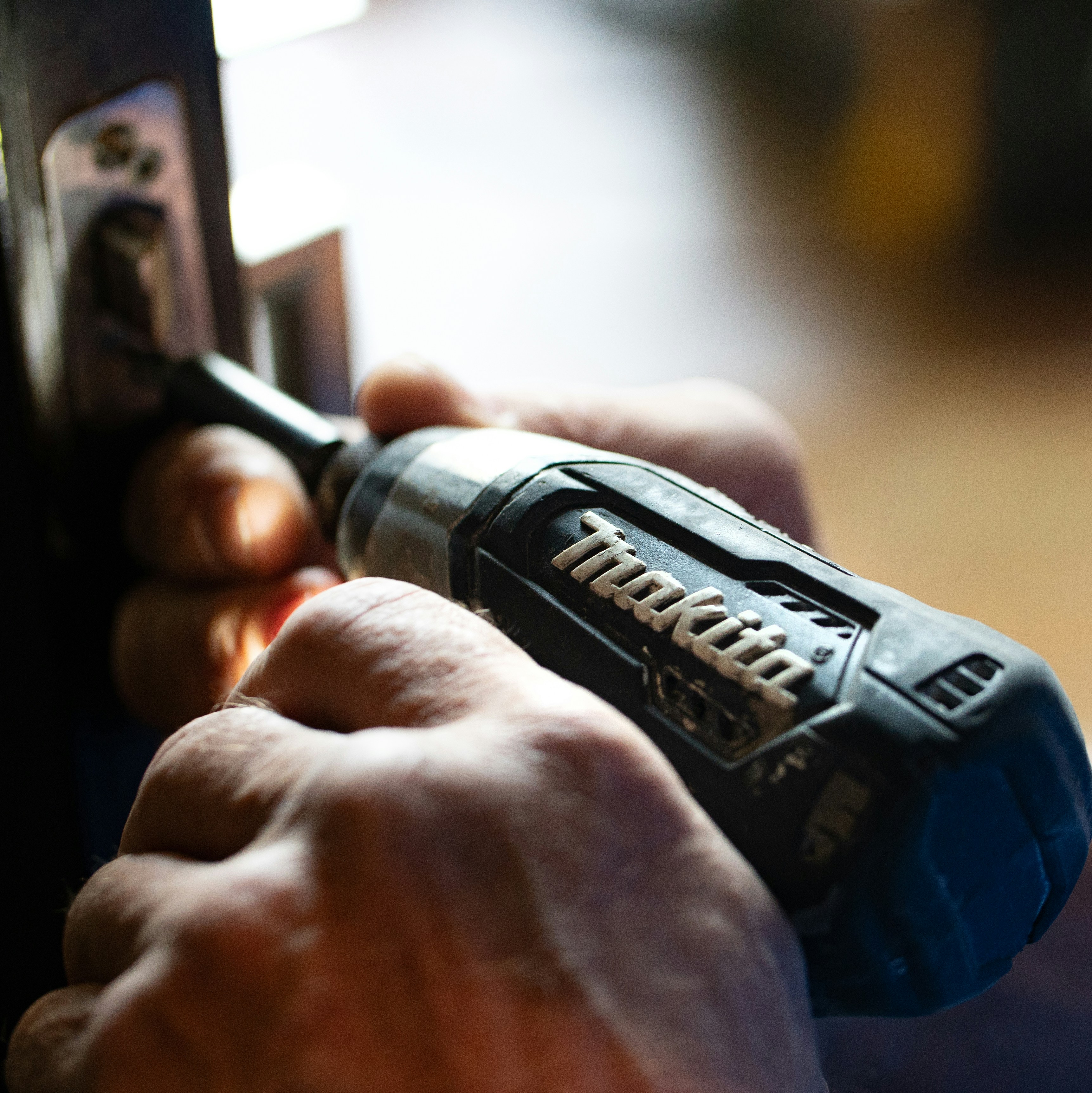 selective focus photography blue and black Makita power drill