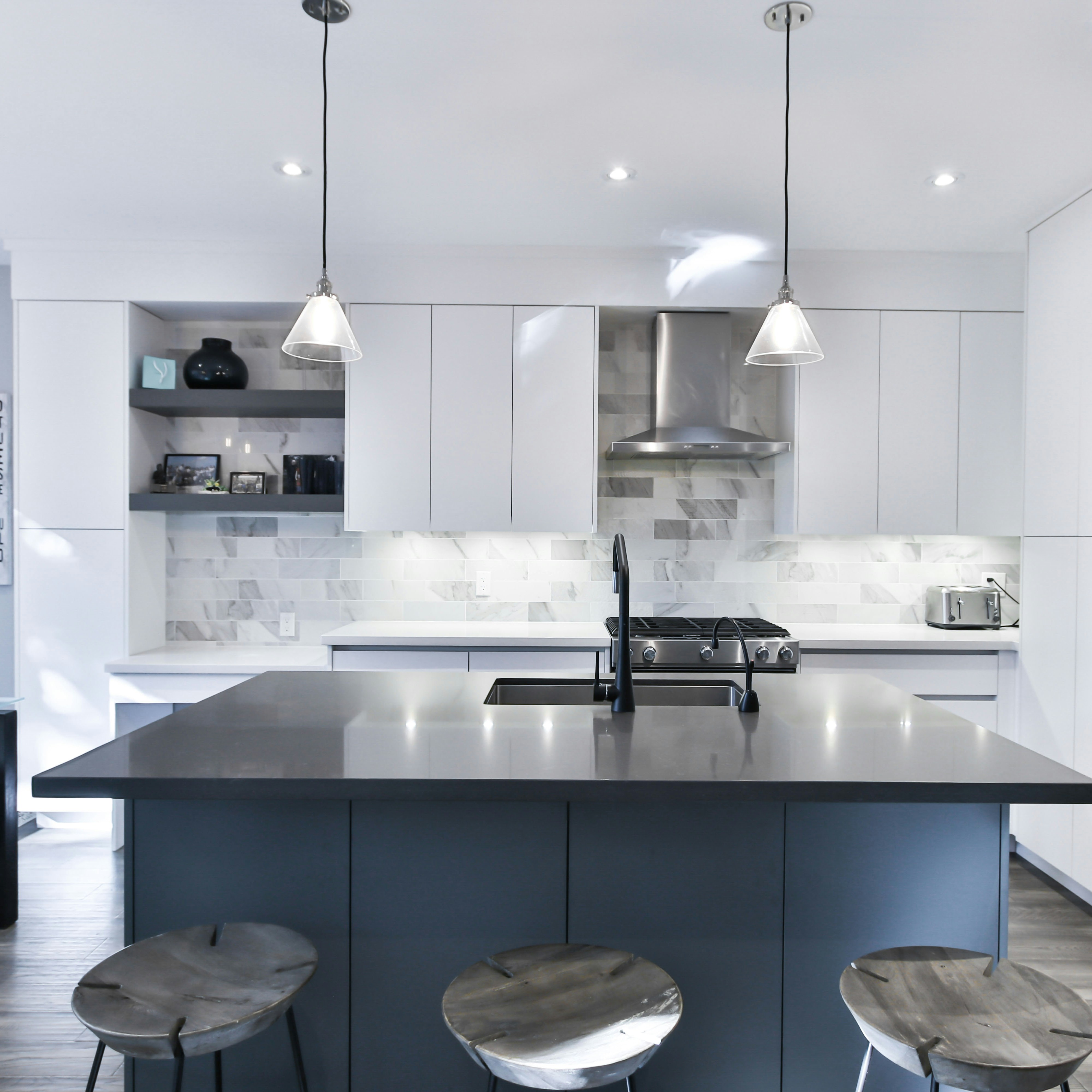 a kitchen with a center island with stools