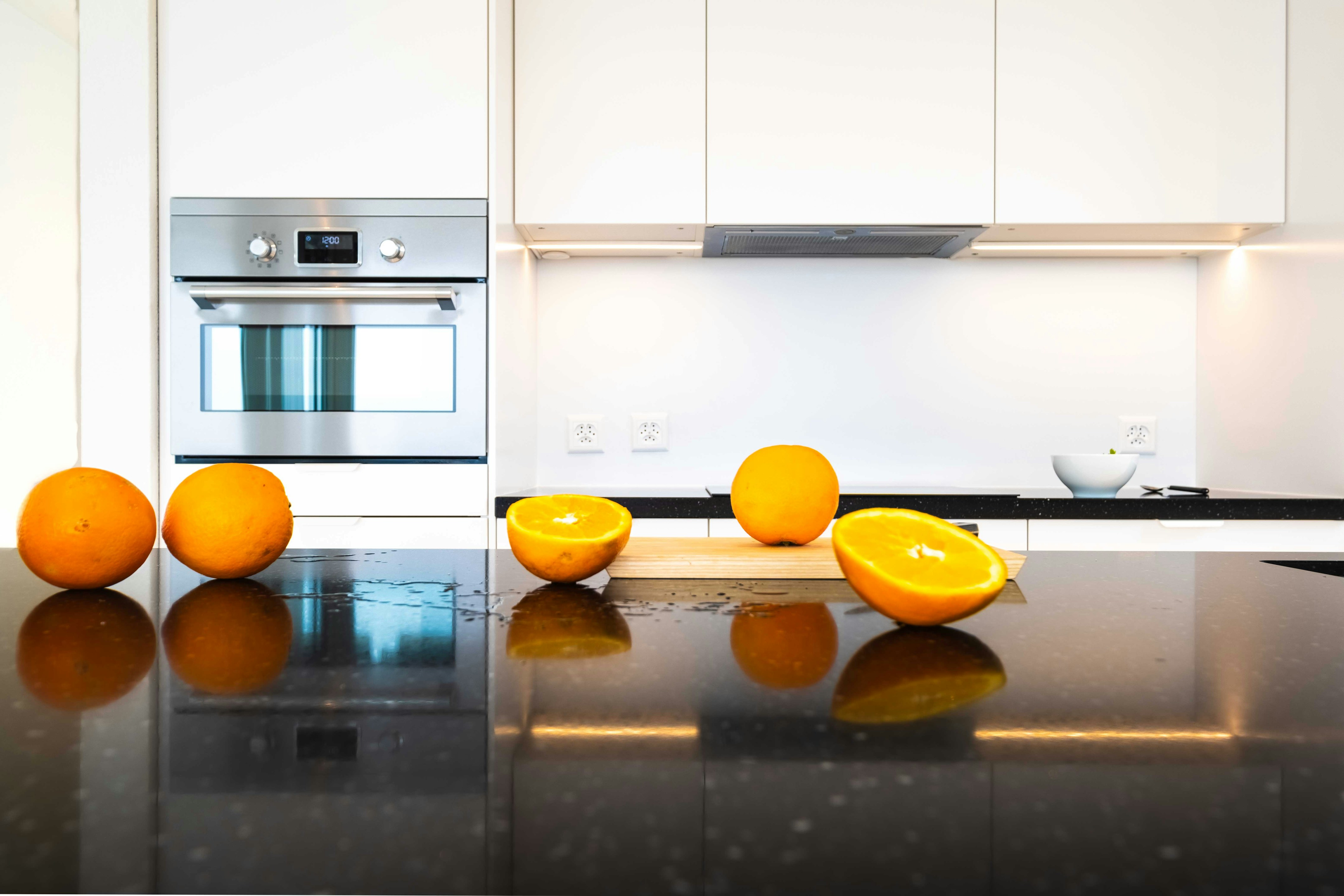 orange fruits on stainless steel kitchen counter