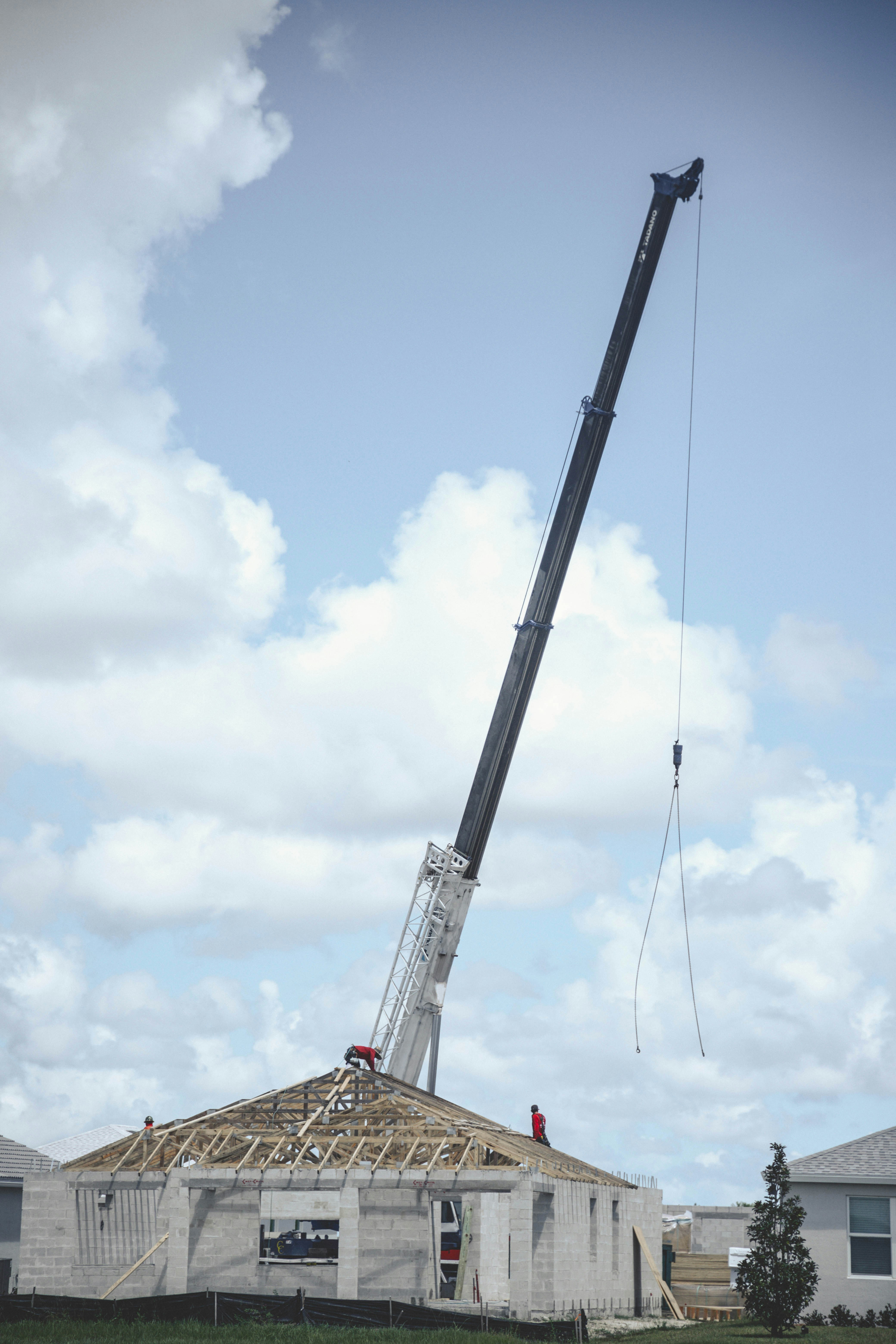 a crane is lifting a house into the air