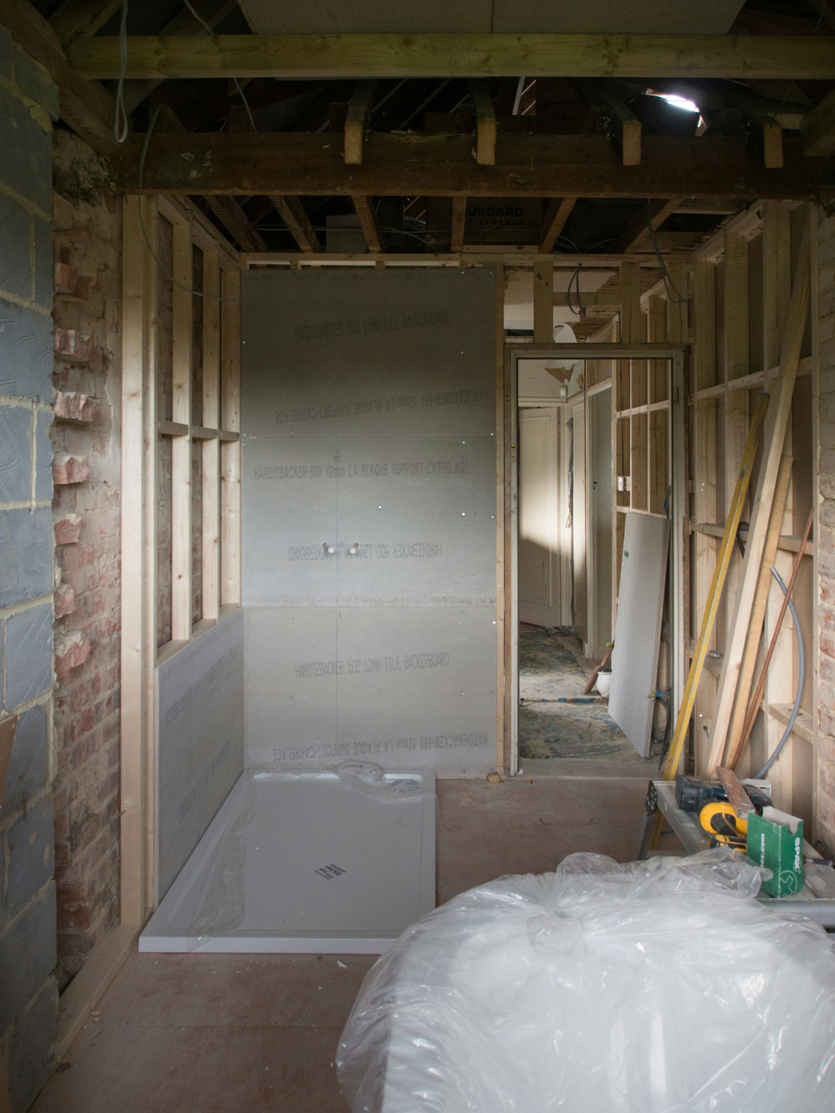 an unfinished bathroom with a tub and toilet