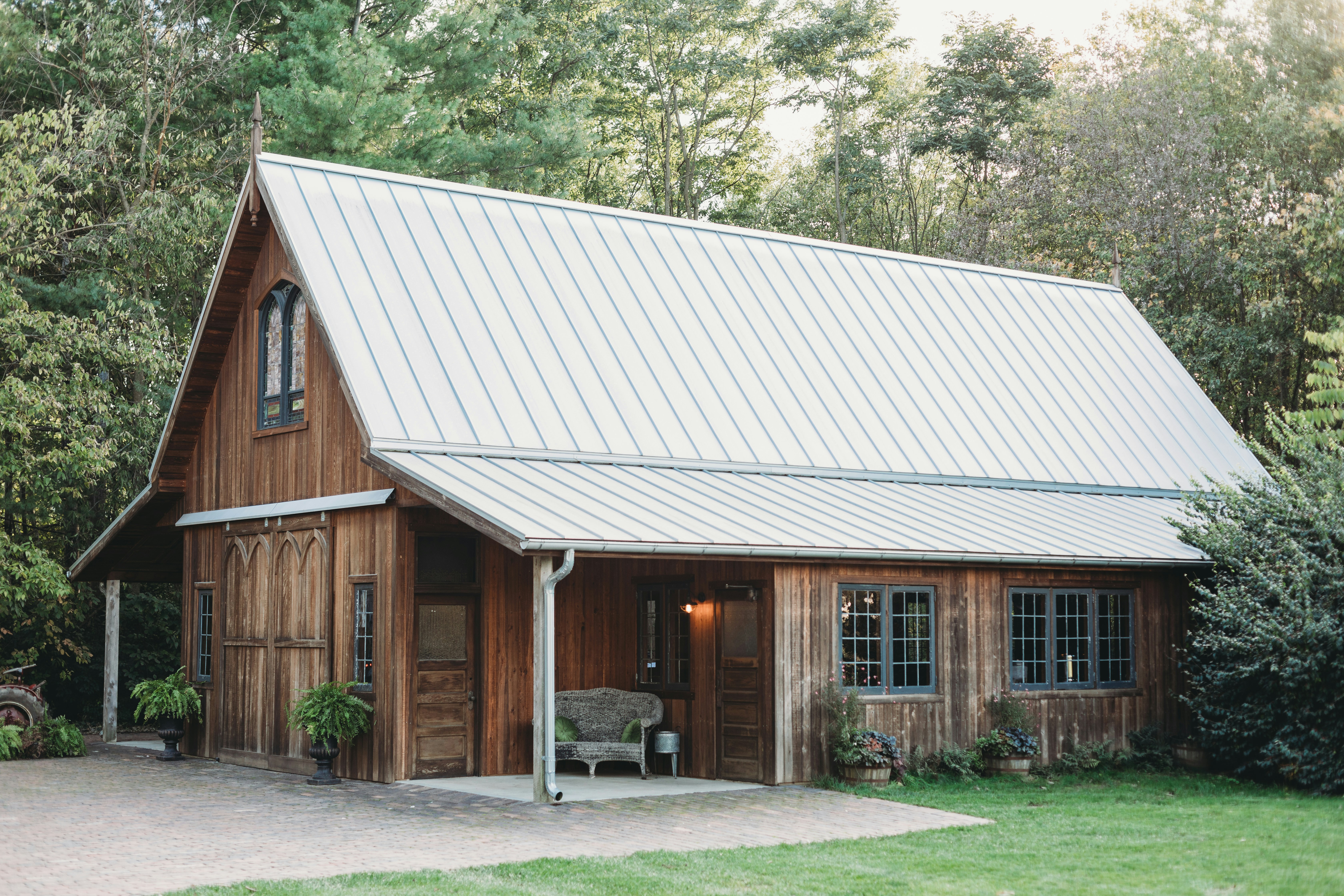 a small wooden building with a metal roof