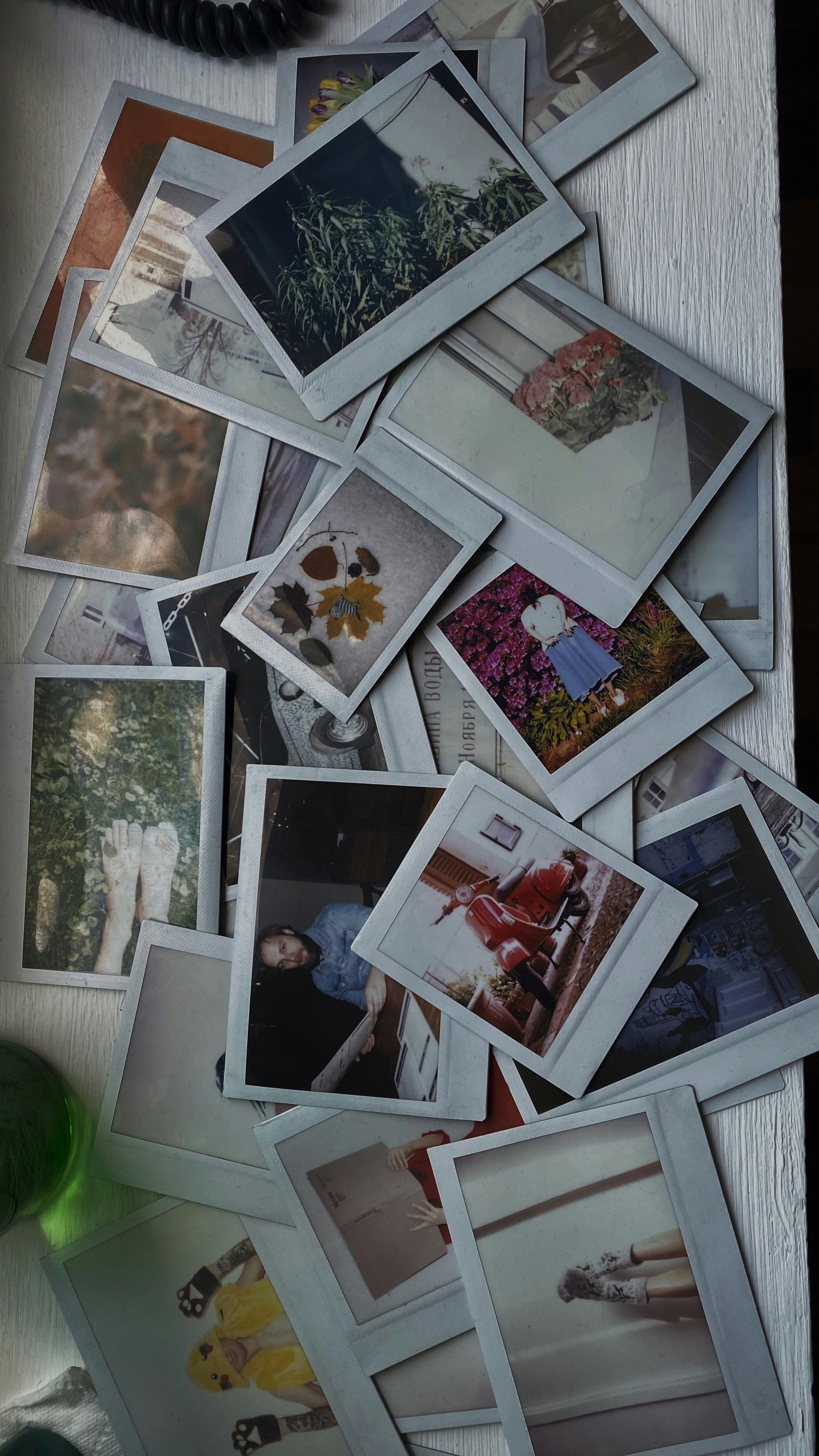 a table topped with lots of polaroid pictures