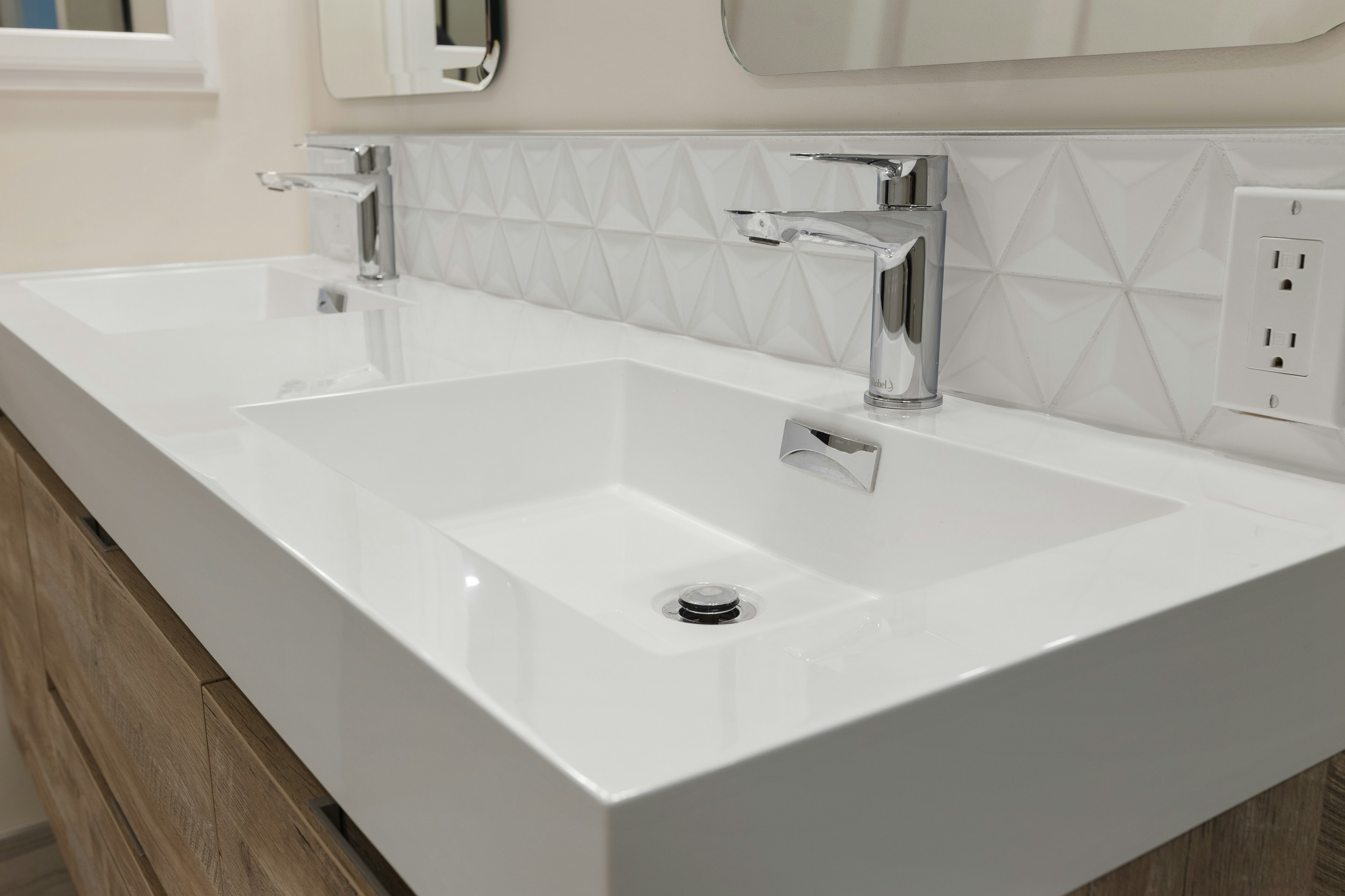 a white sink with a mirror above it