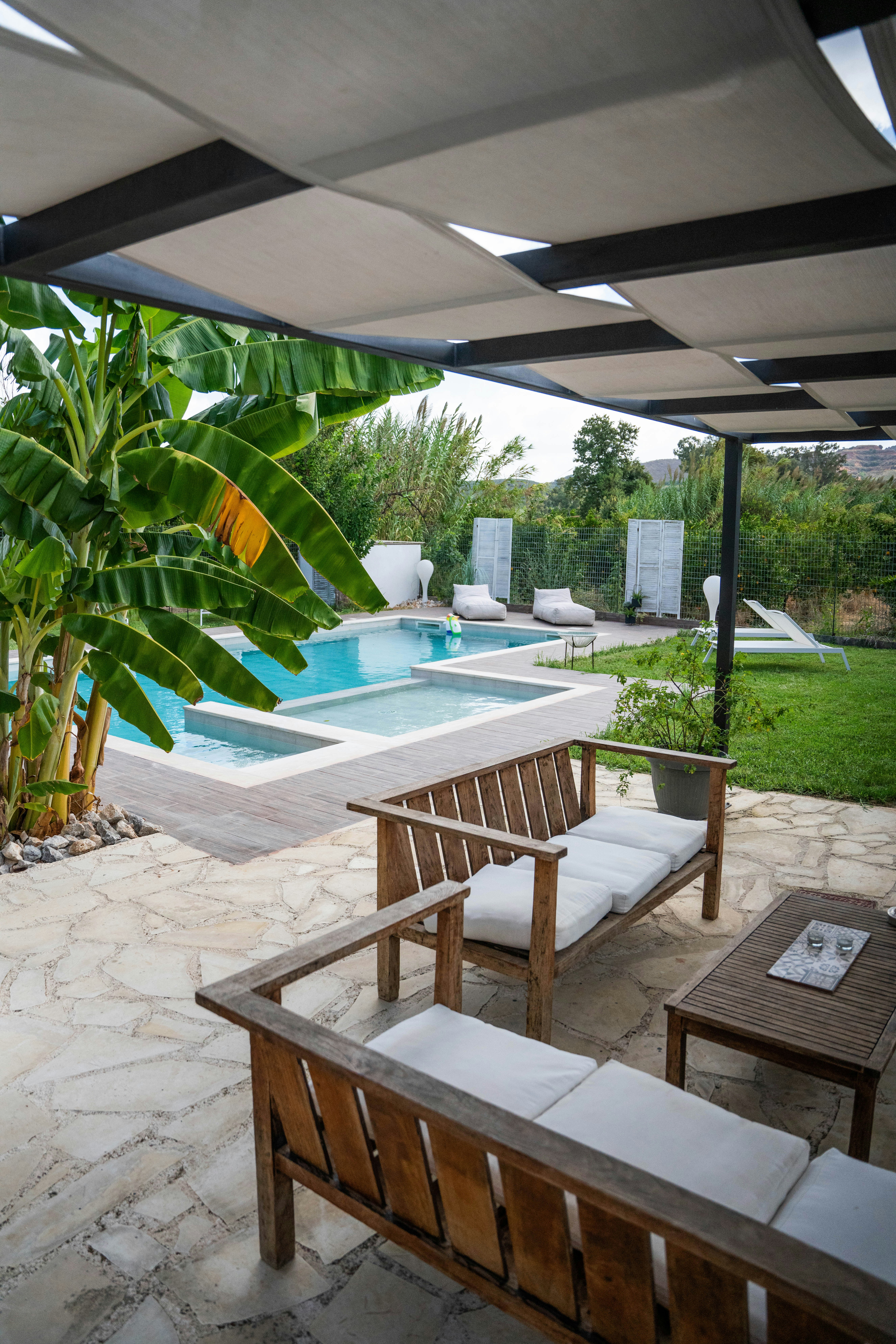 a pool with chairs and a table