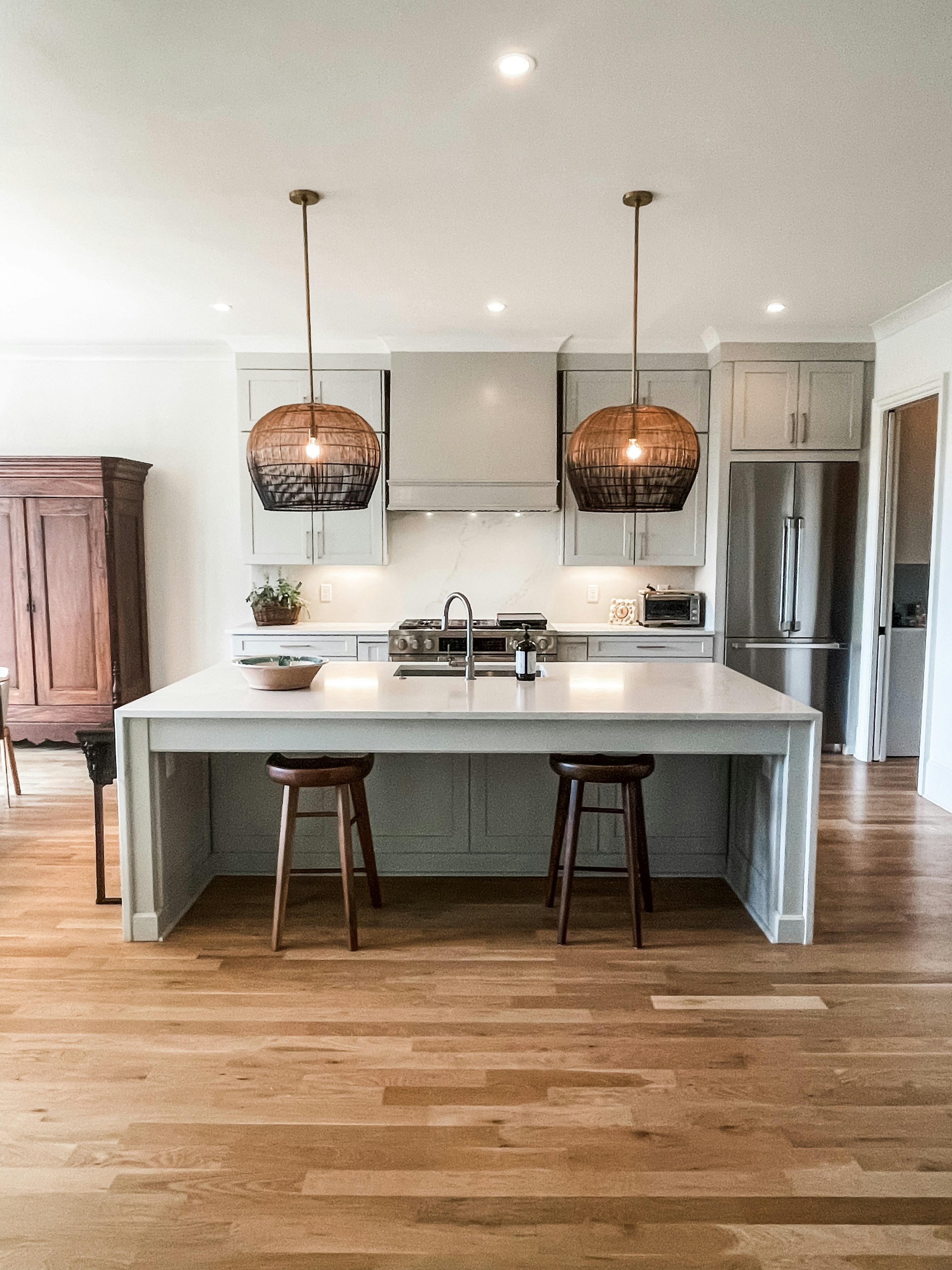 a kitchen with a center island and two stools