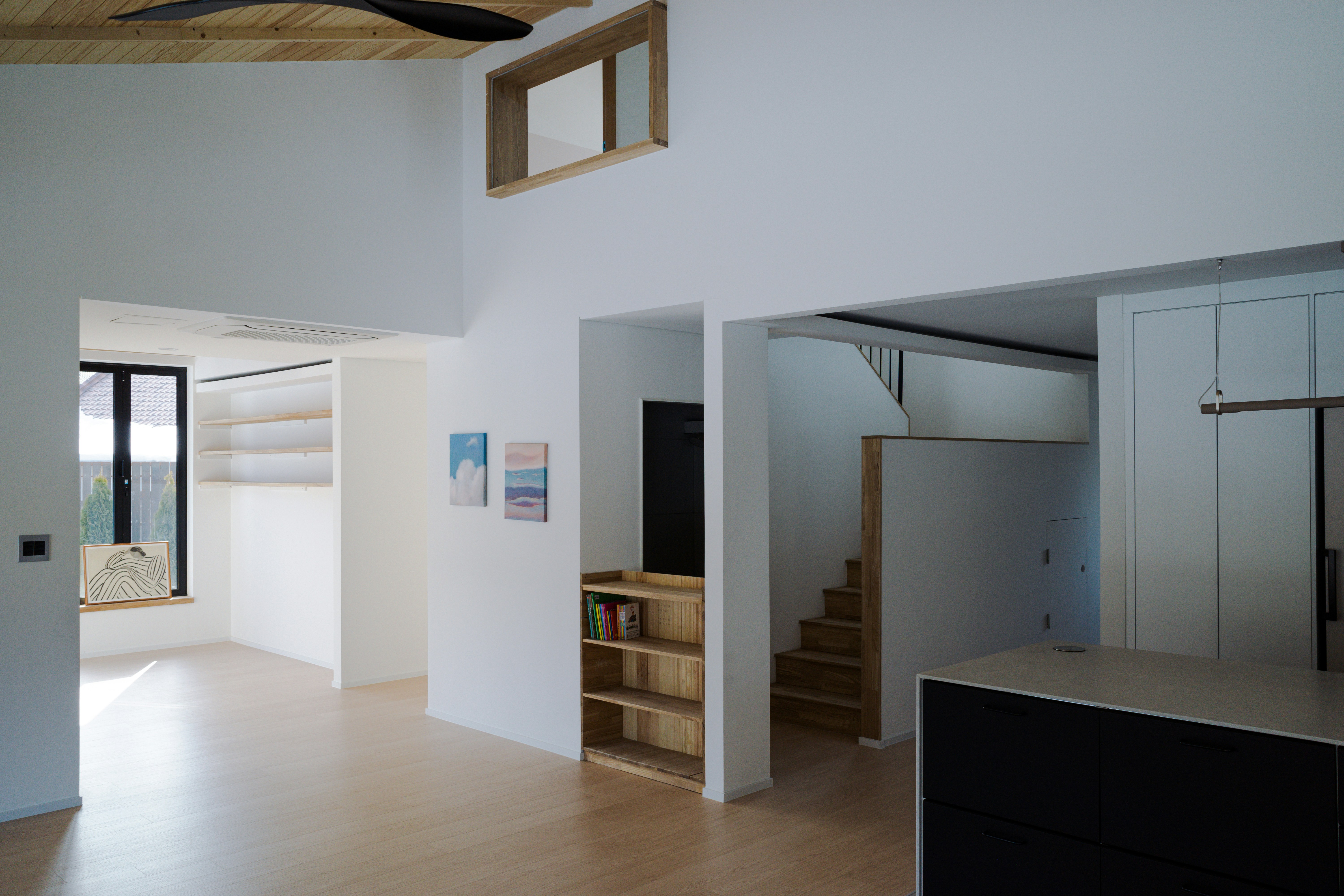 a living room with a staircase and a window