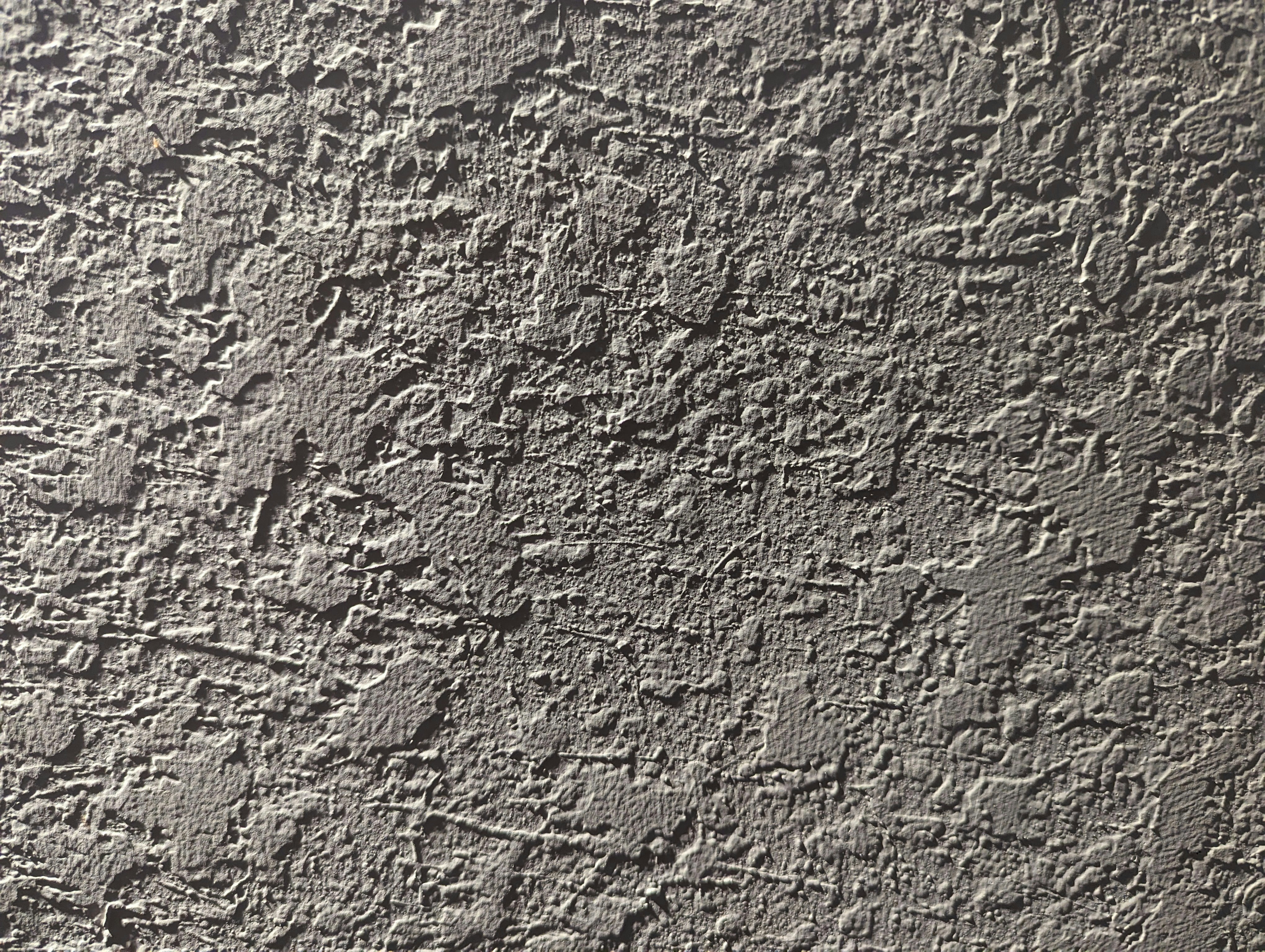 a close up of a cement wall with cracks