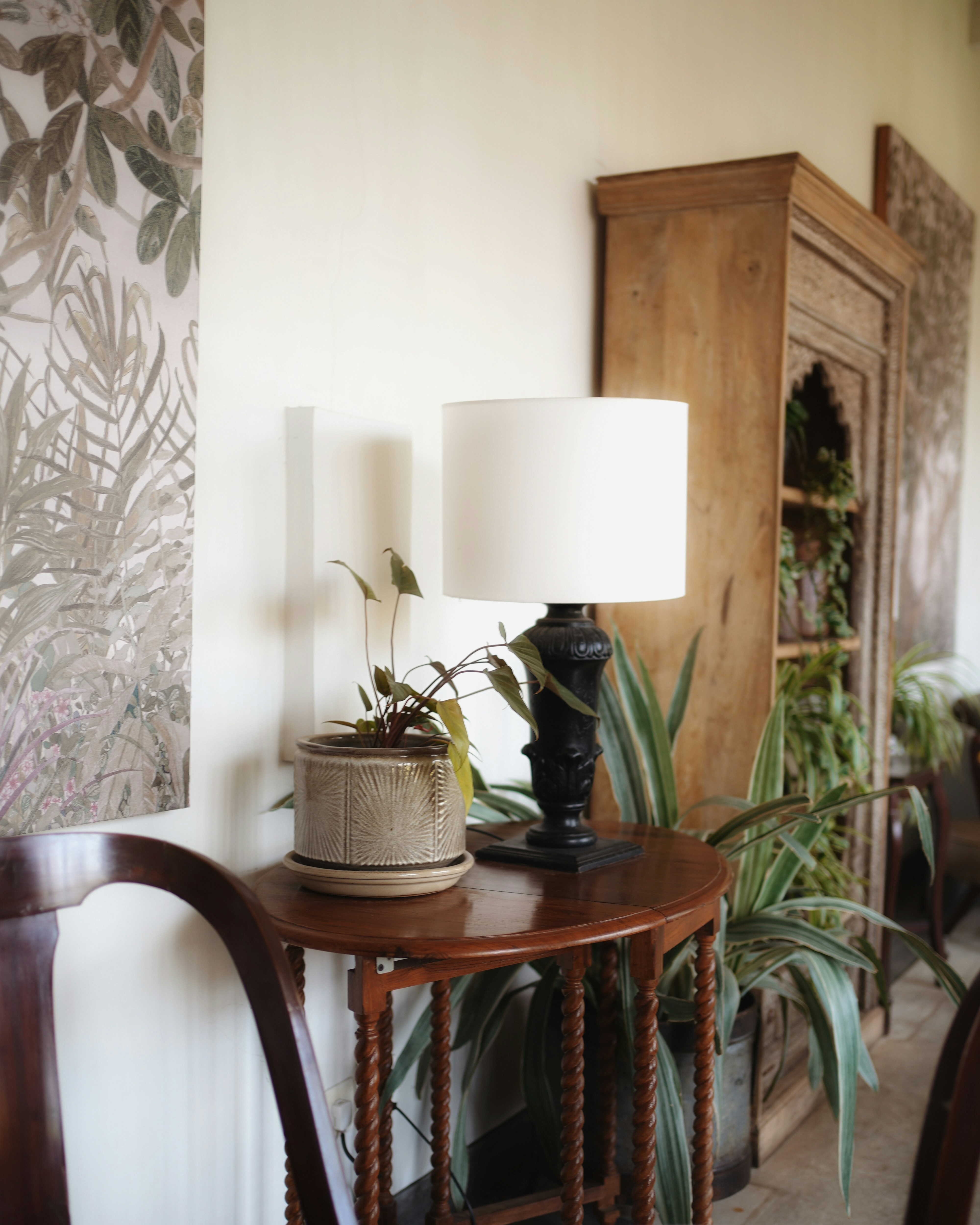 a table with a lamp and a potted plant on it