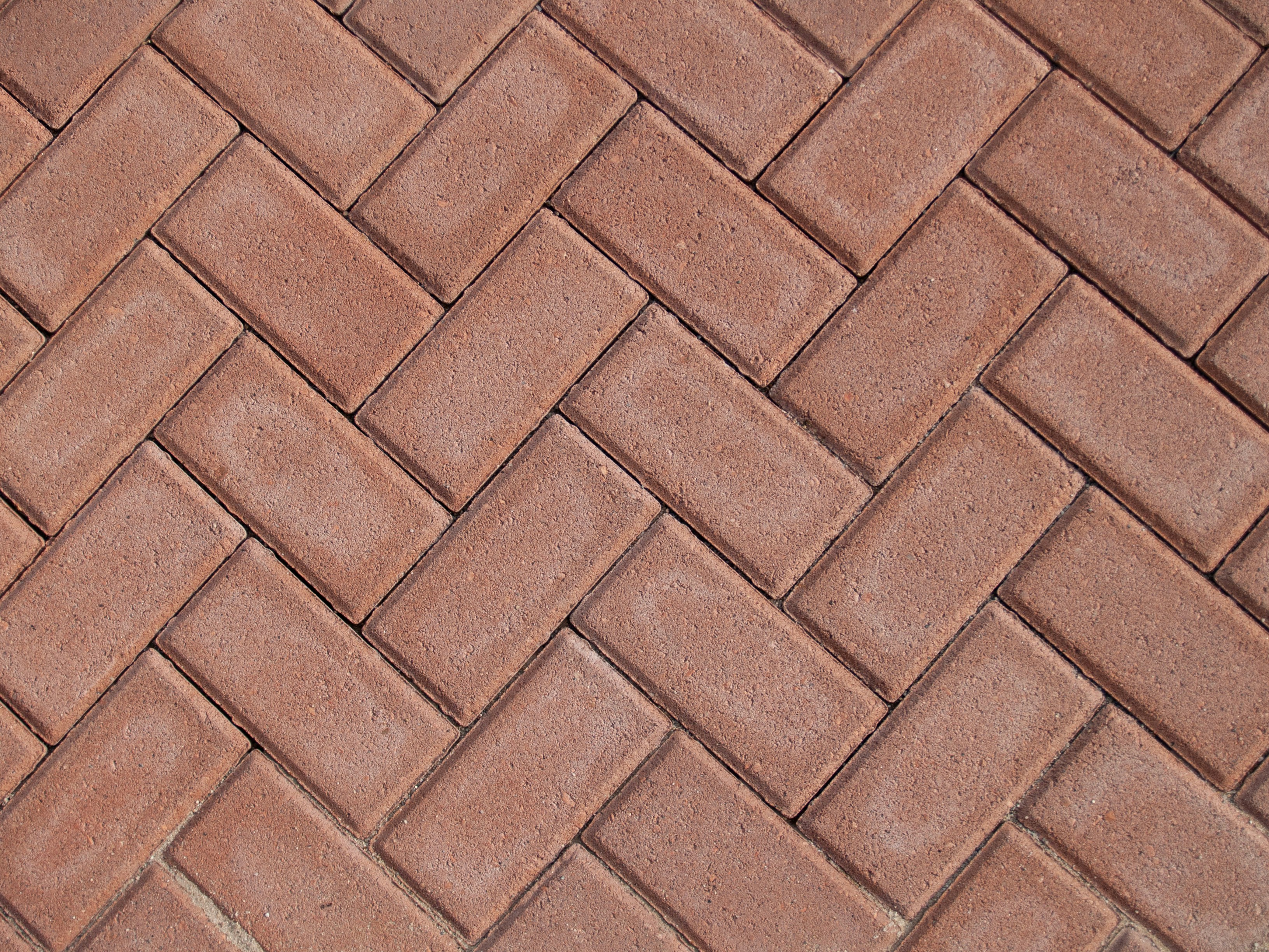 a close up of a red brick sidewalk