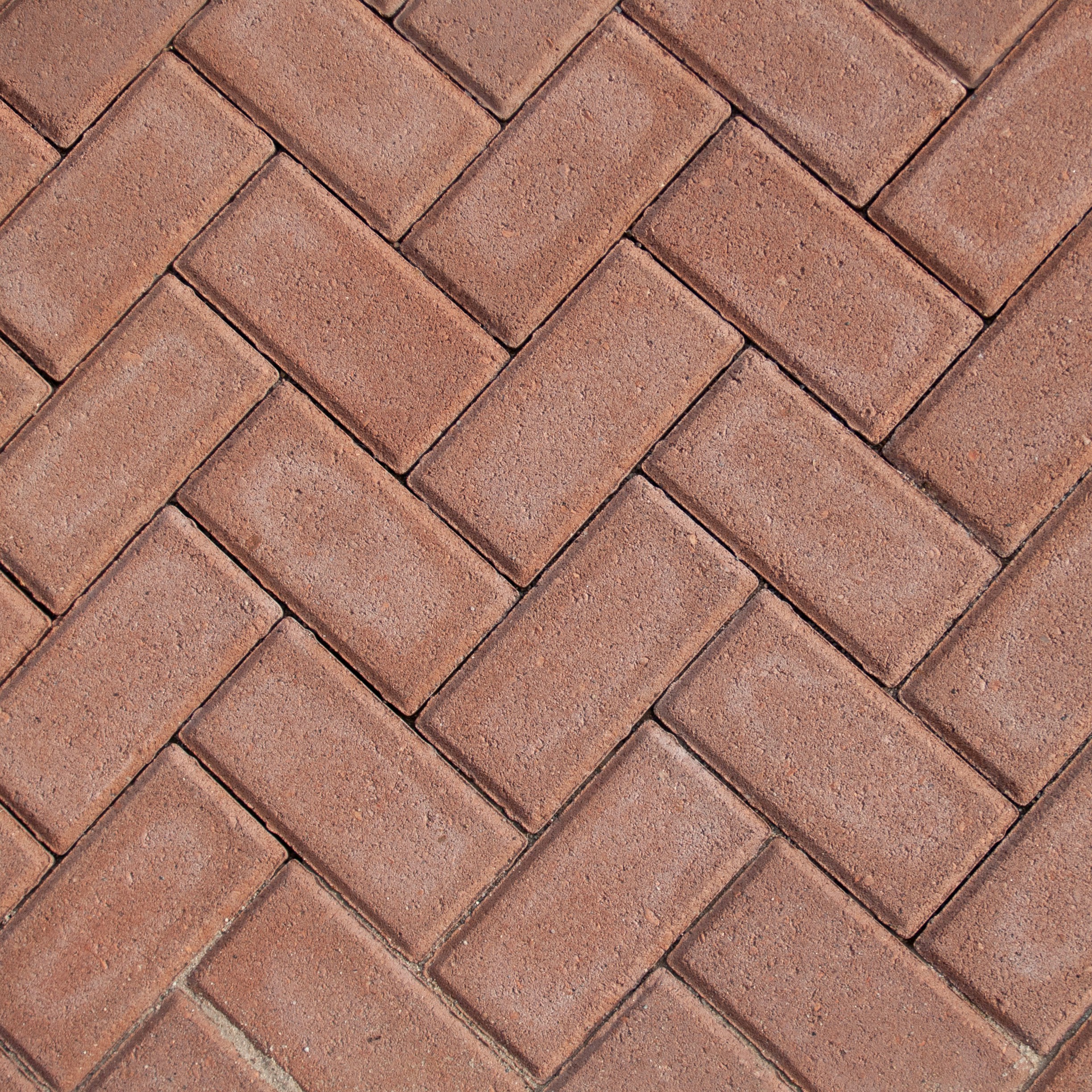 a close up of a red brick sidewalk