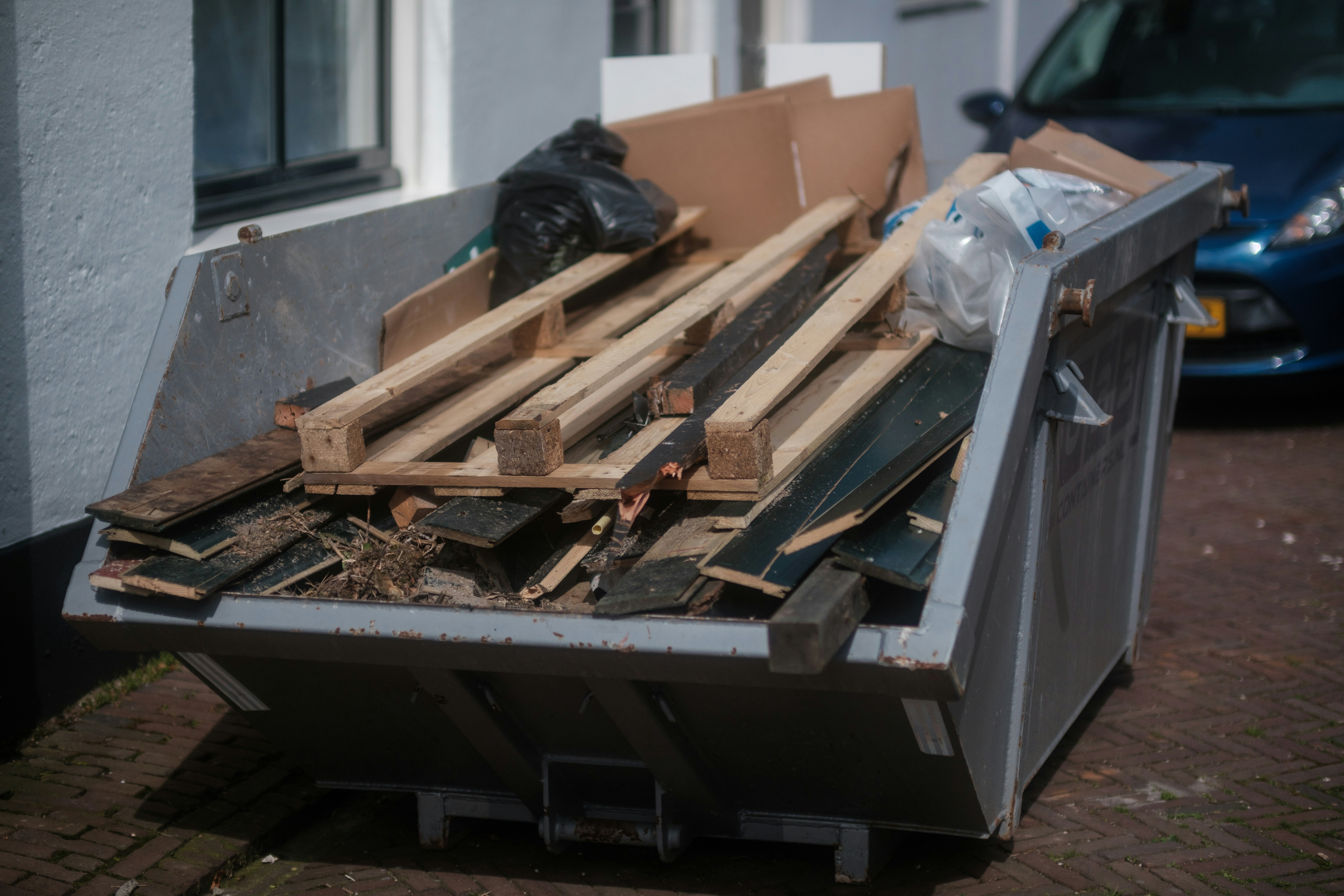 a pile of wood sitting next to a building