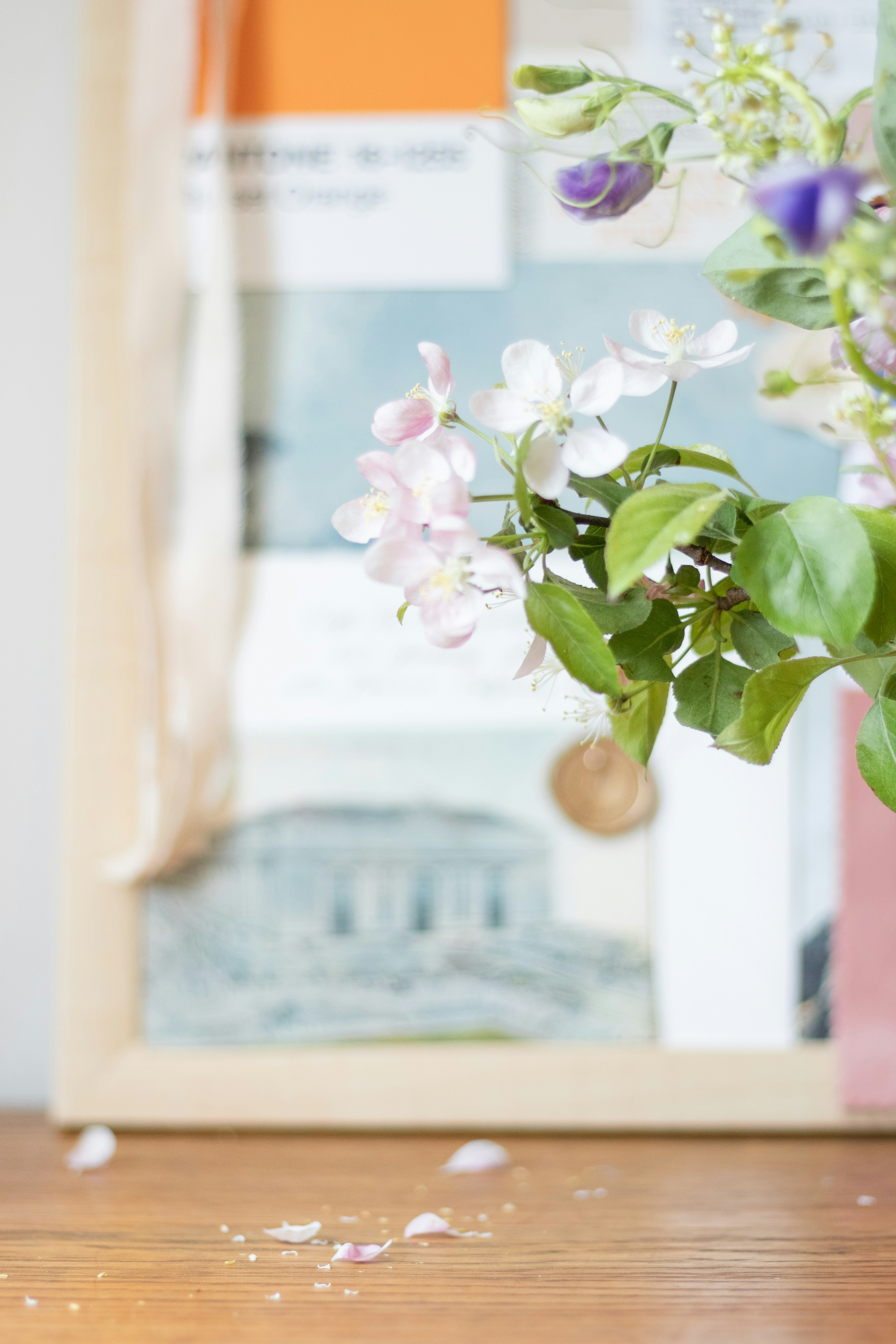 A vase filled with flowers sitting on top of a wooden table