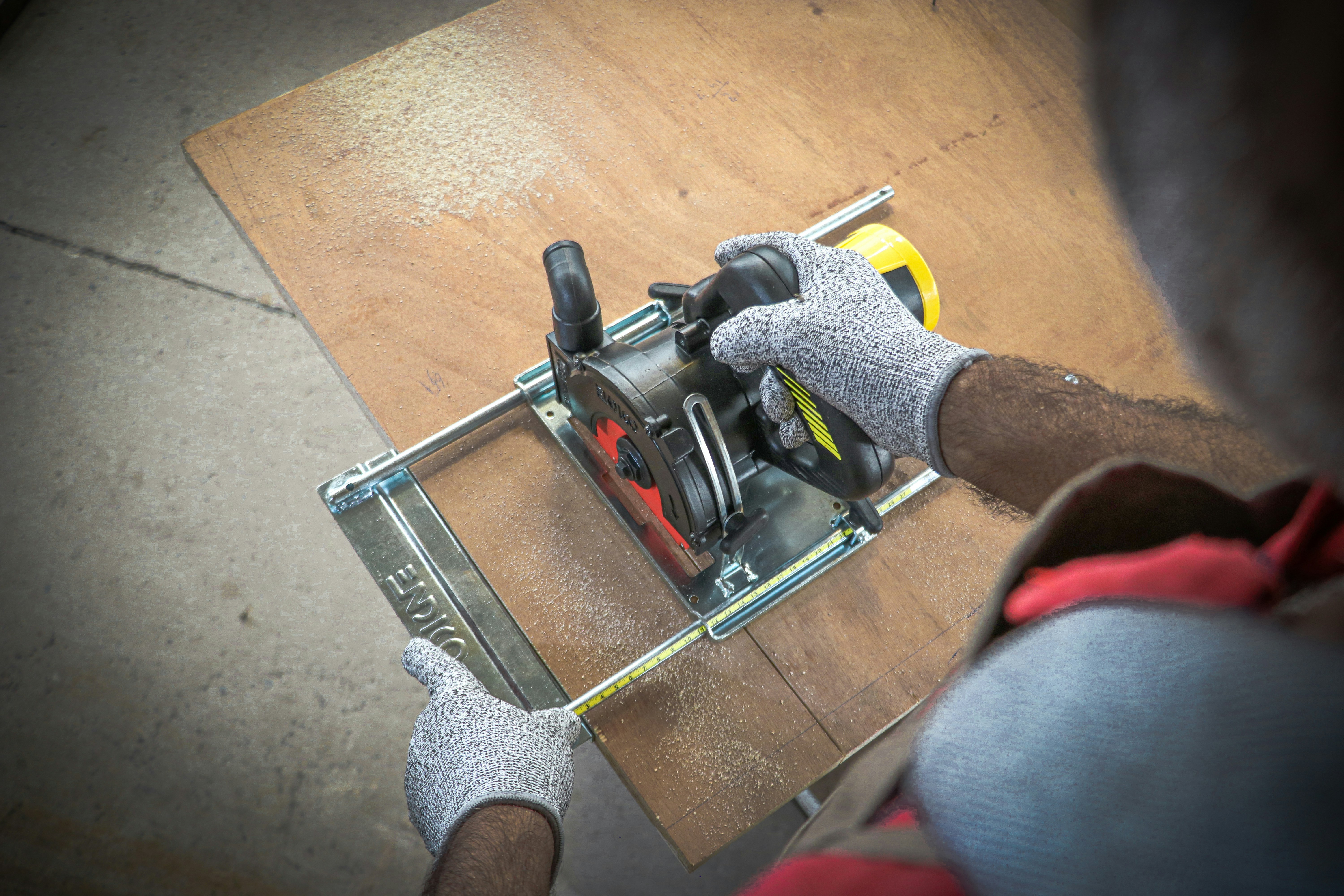 A man using a power tool on a piece of wood