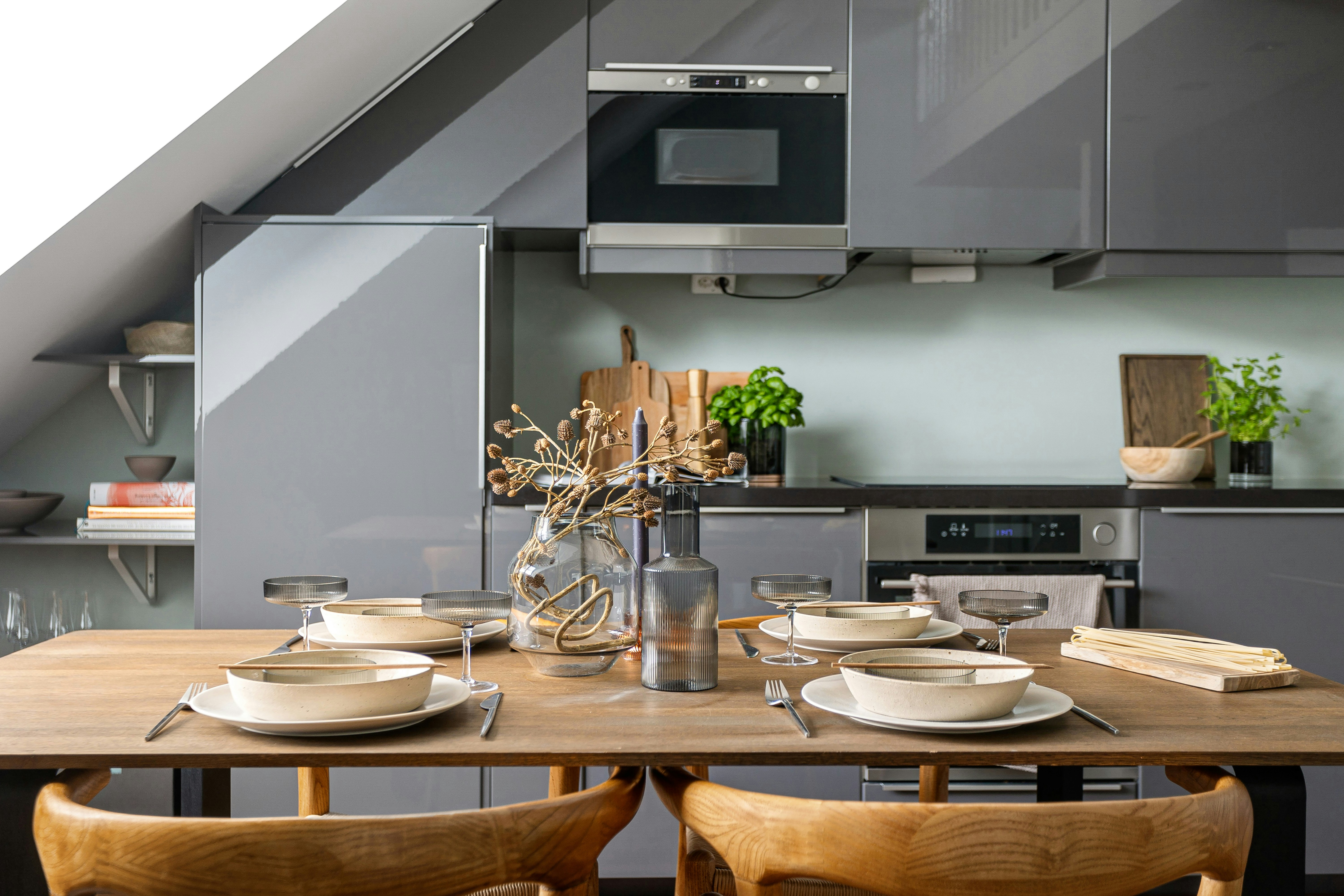 A kitchen with a table and chairs and a microwave