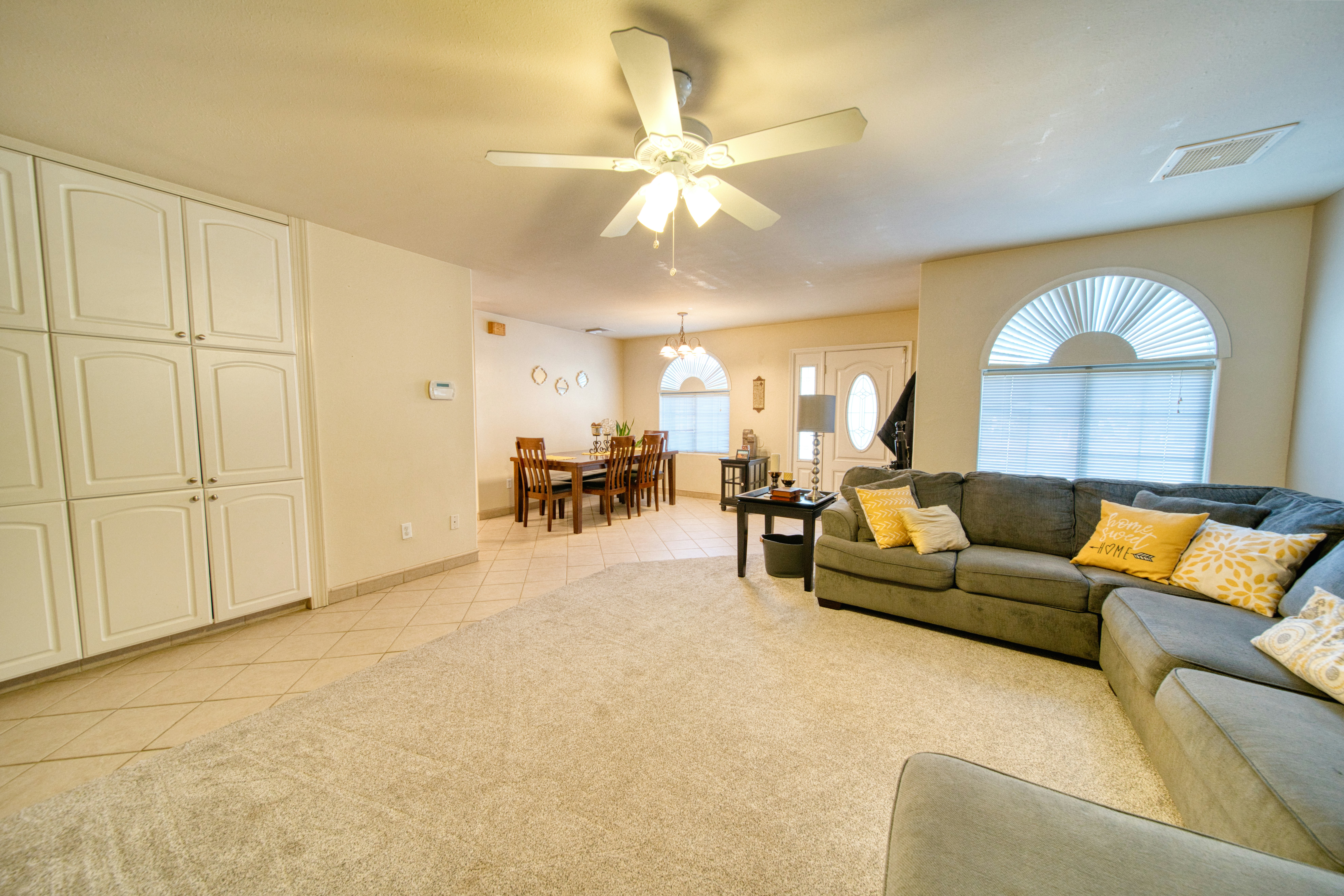 A living room filled with furniture and a ceiling fan
