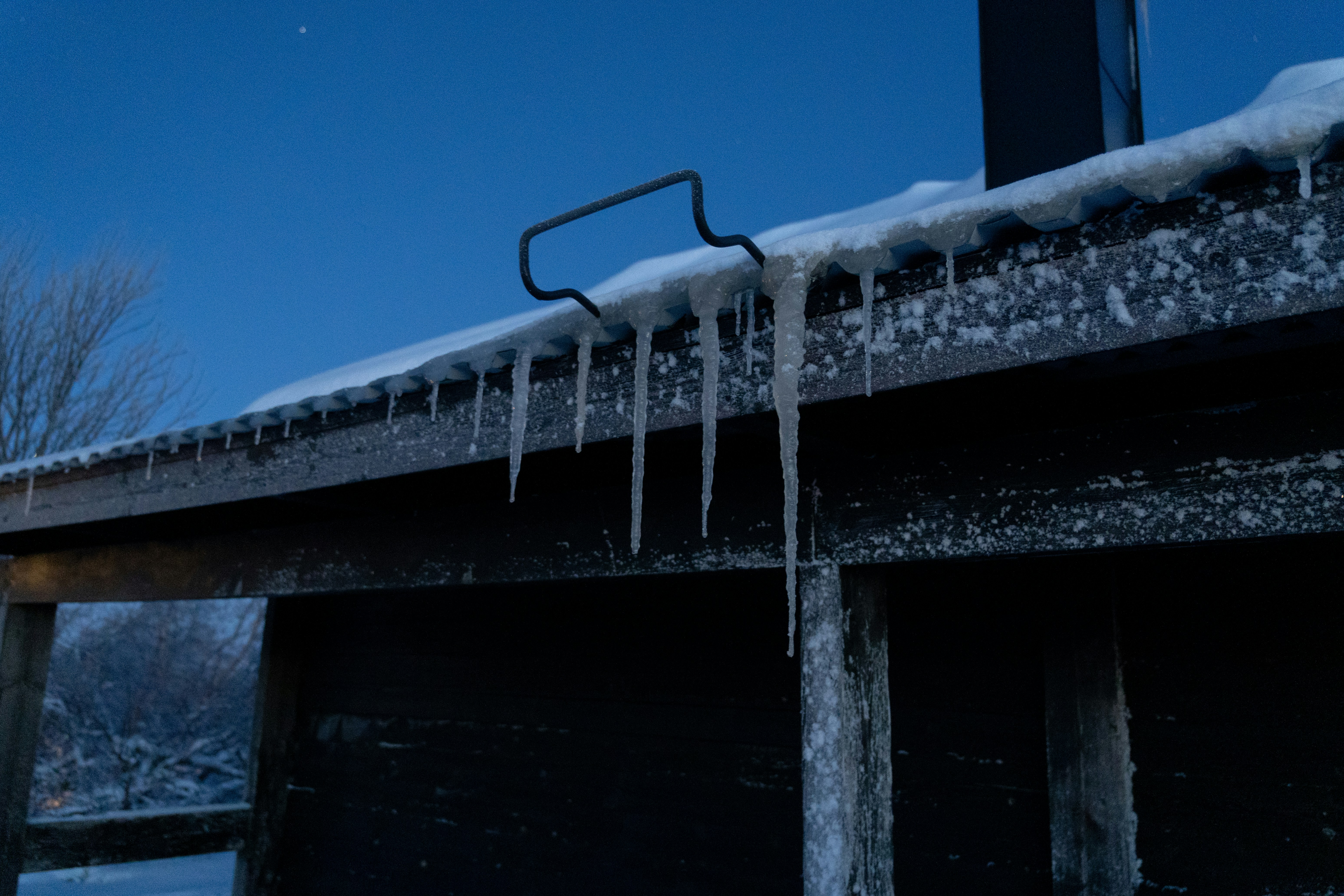 Icicles are hanging off the side of a bridge