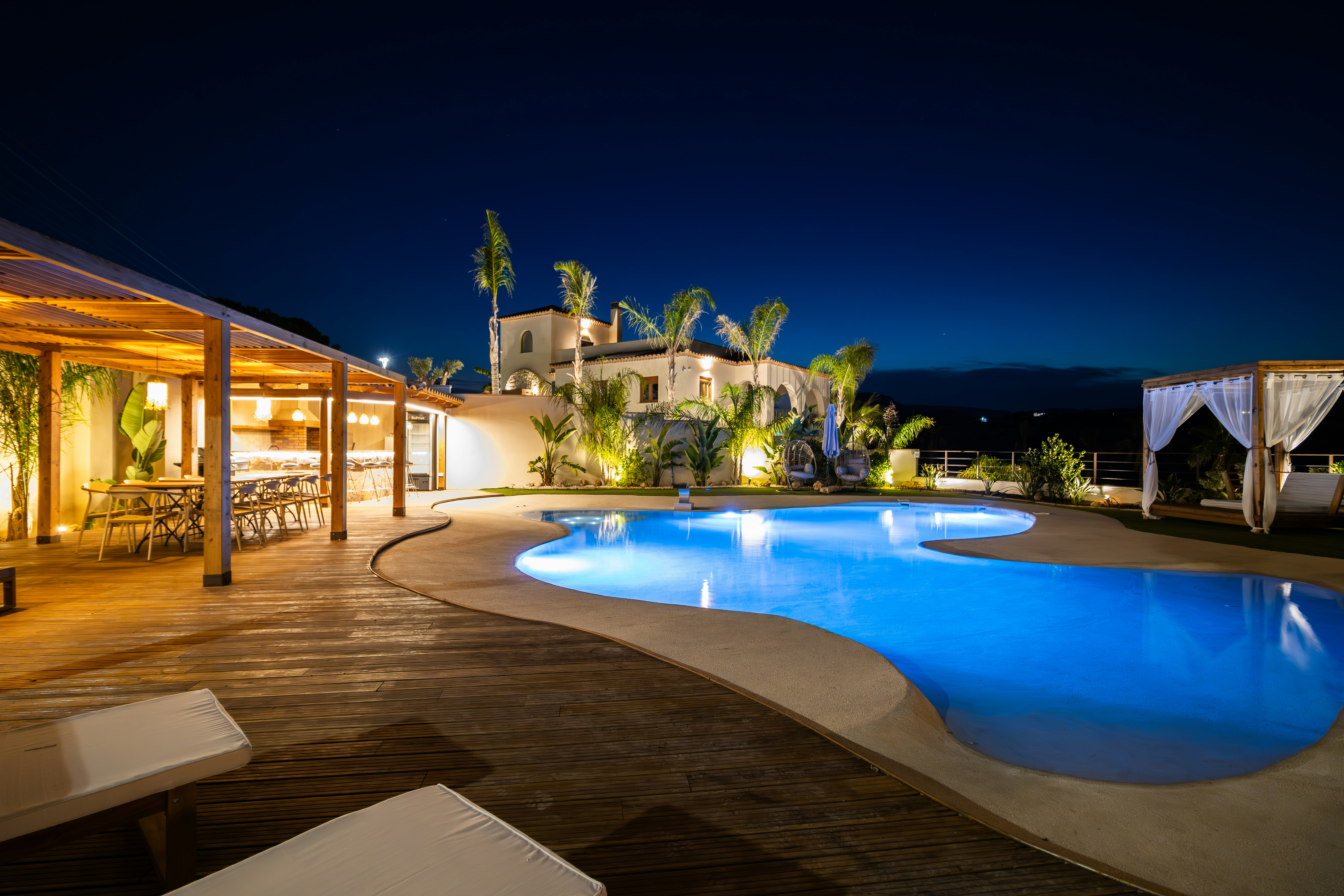 Luxury resort pool area at night with ambient lighting.