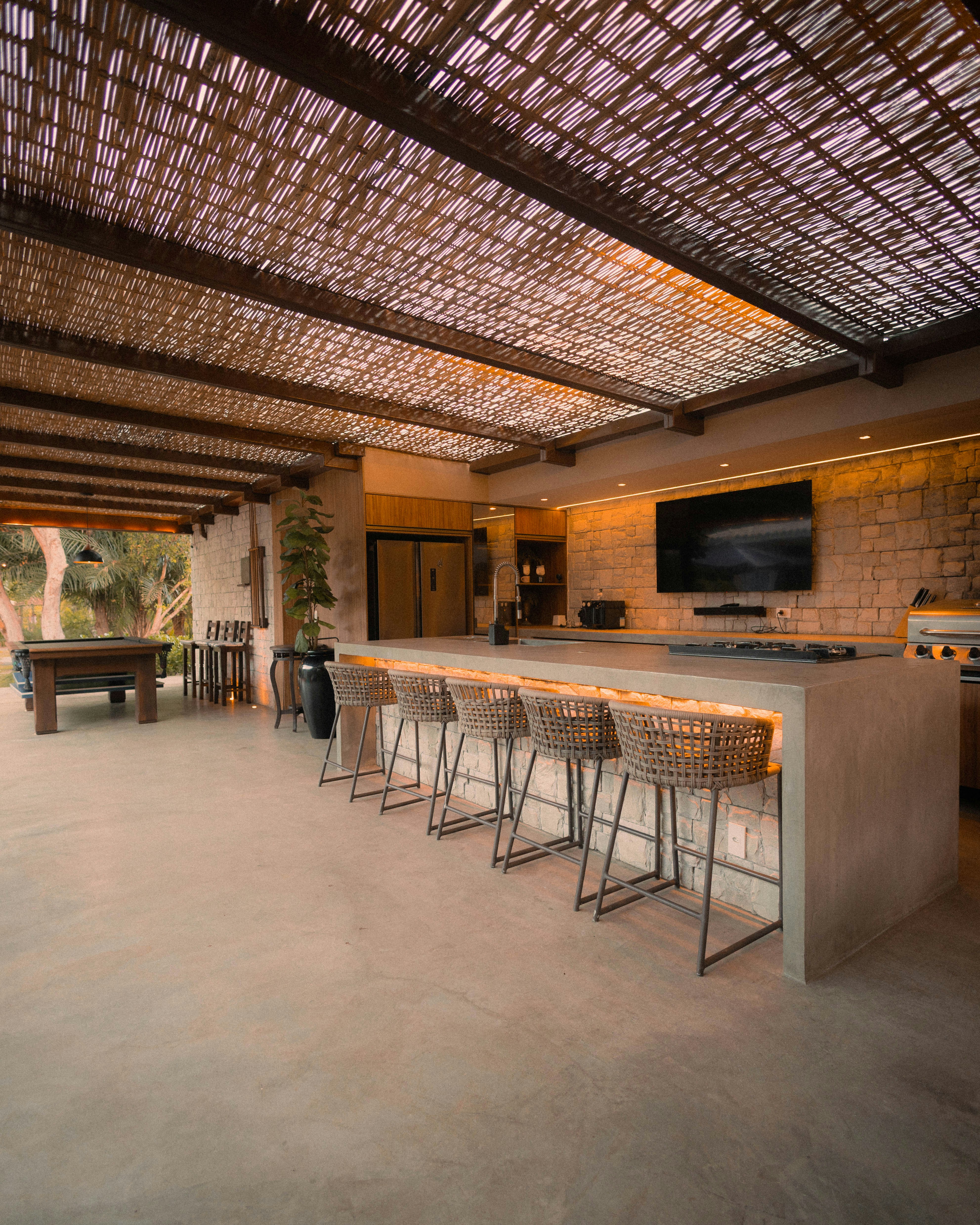 Modern outdoor kitchen with island and bar stools