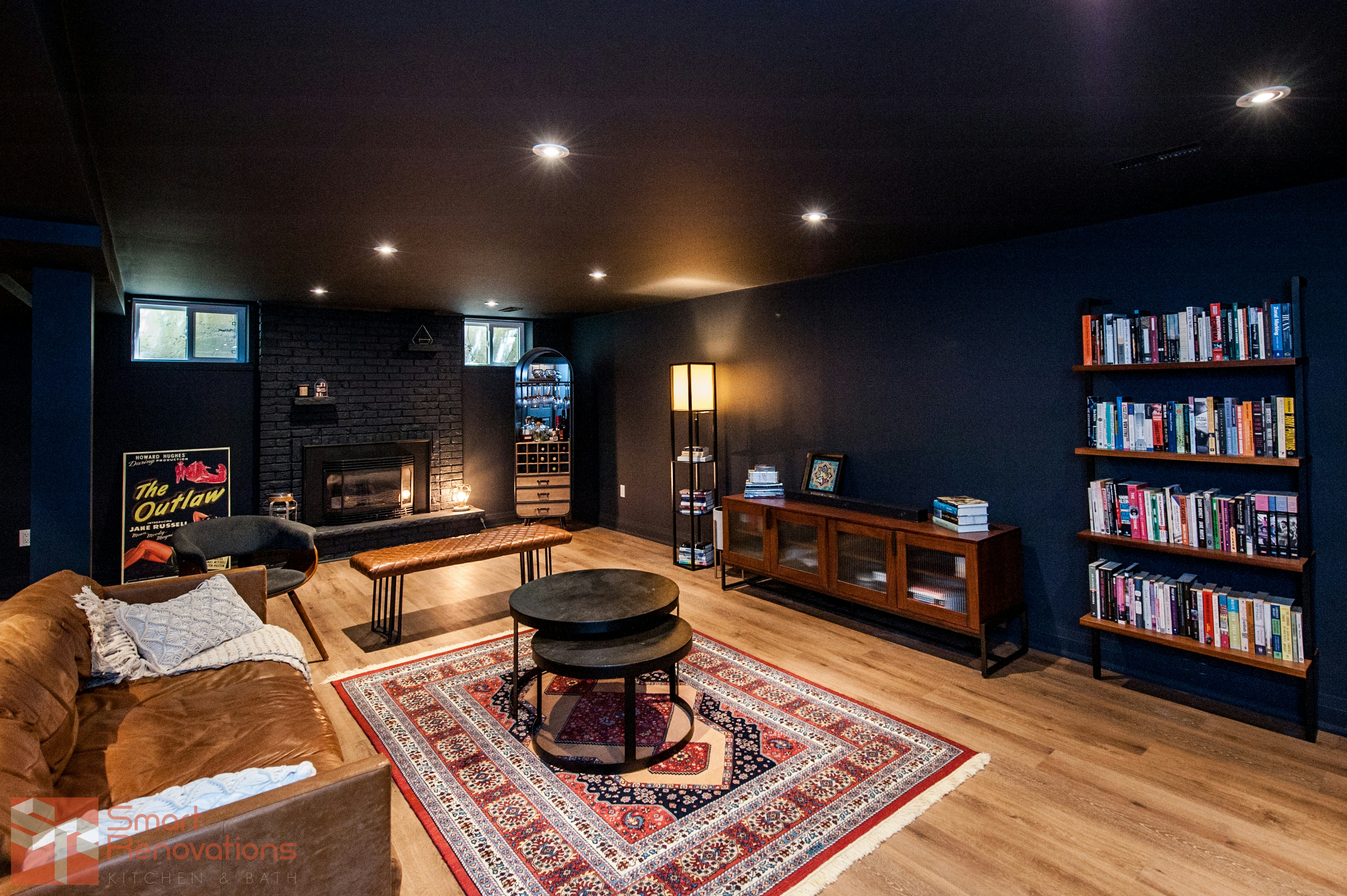 Cozy living room with fireplace and bookshelves.